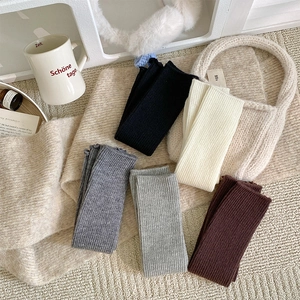 Detailed close-up of ribbed knit leg warmers in five colors for autumn and winter outfits