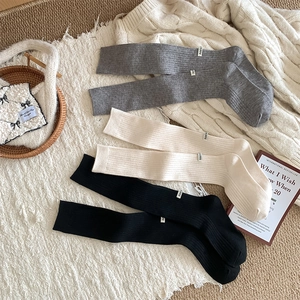 Detailed knit texture and stitched labels on thick wool blend knee high socks for winter