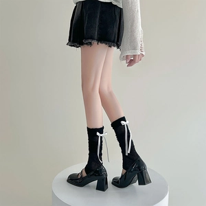 JK style black patent leather Mary Janes with knitted leg warmers and bow ribbons