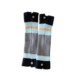 Japanese style striped leg warmers with buttons and colorful knit texture on white background