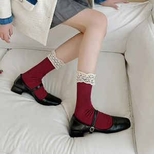 Vintage dark red crew socks with white lace trim paired with black Mary Jane shoes