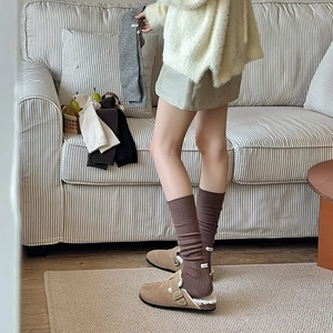 Close-up of ribbed knit wool socks showing stylish fabric labels and soft textures