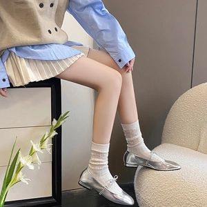 Detail of silver Mary Jane flat shoes with bow strap and white lace mesh socks