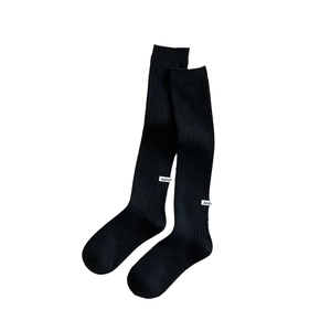 Thick black knitted wool over-the-knee socks with ribbed texture and side label