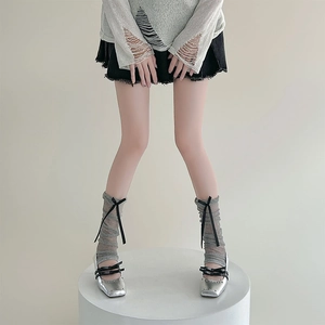 Silver Mary Jane shoes with double black bows and grey ribbon leg warmers on a model