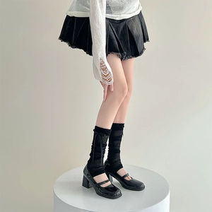 Close-up of black mesh socks with bow detail and matching patent leather Mary Janes