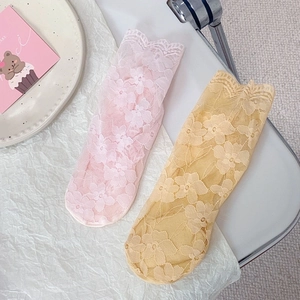 Detailed view of floral lace pattern on breathable pink and yellow mesh socks