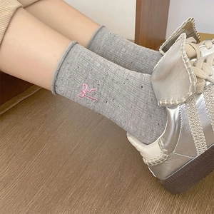 Grey knit mid-calf socks with pink embroidered bow and rolled cuffs for women