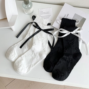 Detail of JK style mid-calf socks with cute satin bows and butterfly knit pattern texture