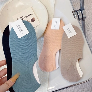 Flat lay of breathable mesh cotton no-show socks in assorted colors with anti-slip heel