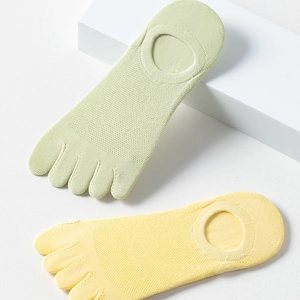 Detail of light green and yellow five-finger socks with breathable mesh and anti-slip grip