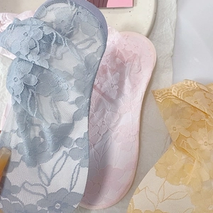 Detailed view of sheer floral lace low-cut socks in blue, pink, and yellow colors