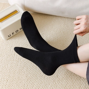 Close-up of black mid-calf socks showing the high-elasticity ribbed cuff for comfort