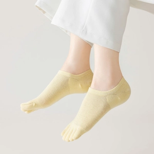 Close-up of light yellow mesh five-finger socks with breathable cotton fabric