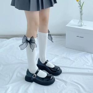 Lolita style Mary Jane shoes with thick soles and white socks featuring black mesh bows
