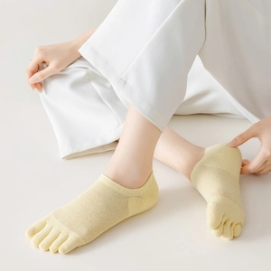 Close-up of light yellow mesh five-finger socks with breathable split-toe design for women