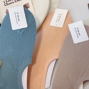 Detailed macro view of mesh breathable invisible socks in light blue, pink and brown