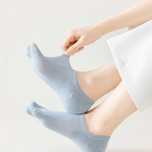 Close-up of light blue mesh five-finger socks with breathable open knit for summer