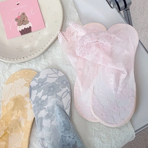 Detailed view of lace ankle socks with floral mesh textures in soft pastel colors