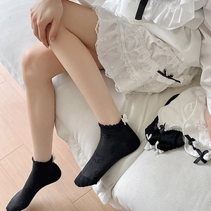 Detail of black JK socks with lace trim and bowknot, featuring delicate butterfly patterns