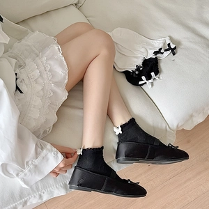 Detail of JK style ankle socks with delicate lace trim and 3D bows in black and white