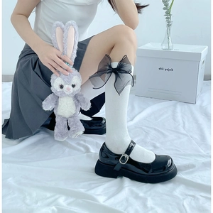 Detail of black Mary Jane shoes with mesh bow knee-high socks in Lolita style