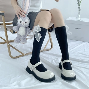 Japanese JK style black knee-high socks featuring delicate white mesh bows and black shoes