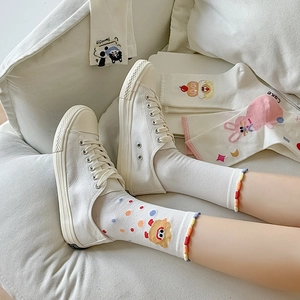 Close-up of white crew socks featuring cute cartoon bear and rabbit patterns