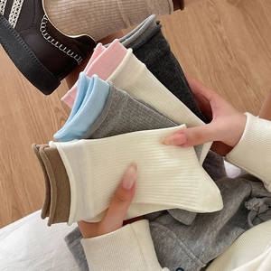 Close-up of assorted ribbed cotton crew socks in pastel colors for a cozy lifestyle look