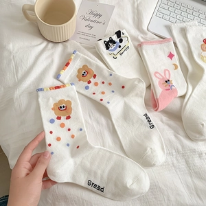 Close-up of cute cartoon animal embroidery and colorful wavy ruffled edges on cotton socks
