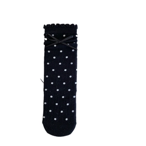 Knit cotton baby knee-high socks featuring white polka dots and black ribbon bows
