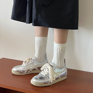 Silver metallic low top sneakers with cream stripes and retro rubber sole for women