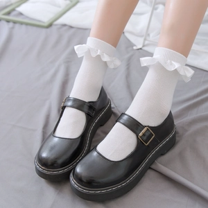 Japanese style white lace socks with mesh pattern paired with black Mary Jane shoes