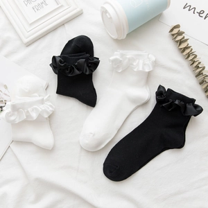 Detail of sweet ruffle trim on breathable cotton crew socks in black and white colors