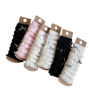 Japanese ballet style knitted leg warmers with ribbon bows in black, pink, and beige