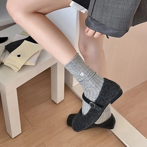 Grey vertical stripe socks with heart embroidery worn with black Mary Jane flats
