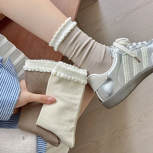 Japanese style frilly white crew socks for women featuring ribbed texture and lettuce trim