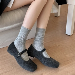 Grey striped crew socks with heart embroidery worn with dark grey tweed Mary Jane shoes