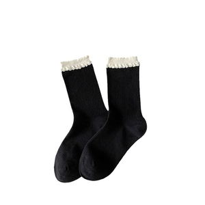 Classic black mid-calf socks for women featuring elegant white ruffle cuffs and ribbed texture
