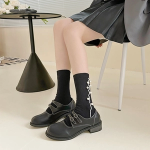 Women's black Mary Jane shoes with double straps and pearl-embellished ruffled socks