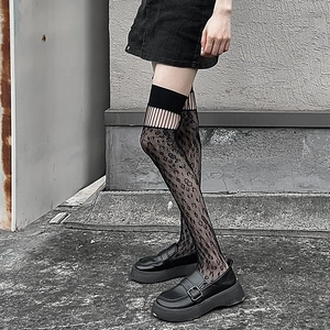 Detailed view of black leopard lace over-knee socks with mesh cutout and wide top band