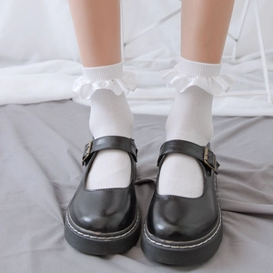 Women's white mesh lace socks paired with black platform Mary Jane shoes in Japanese style