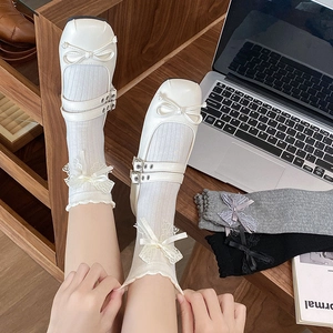 Detailed view of lace trim and satin bows on three-color ballet-style crew socks