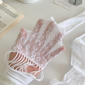 Detailed view of white mesh lace stockings featuring elegant fringe hem design