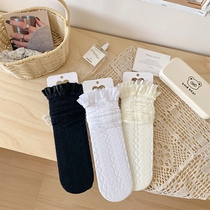 Three pairs of Lolita lace trim calf socks in black and white with eyelet patterns