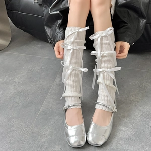 White balletcore knit leg warmers with ribbons paired with silver Mary Jane shoes
