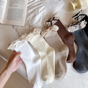 Detail of five-color mid-tube socks with vintage lace trim and delicate ribbon bows