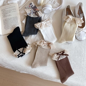 Detail of five-color cotton crew socks with delicate lace trim and ribbon bows