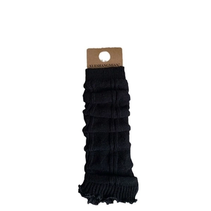 Knit leg warmers in black ribbed fabric with ruffled edges and elastic cuffs for women