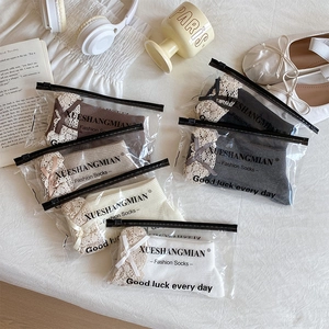 Detailed view of assorted cotton crew socks with lace trim and bows in a cozy setting